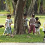 Children playing together in a grassy park